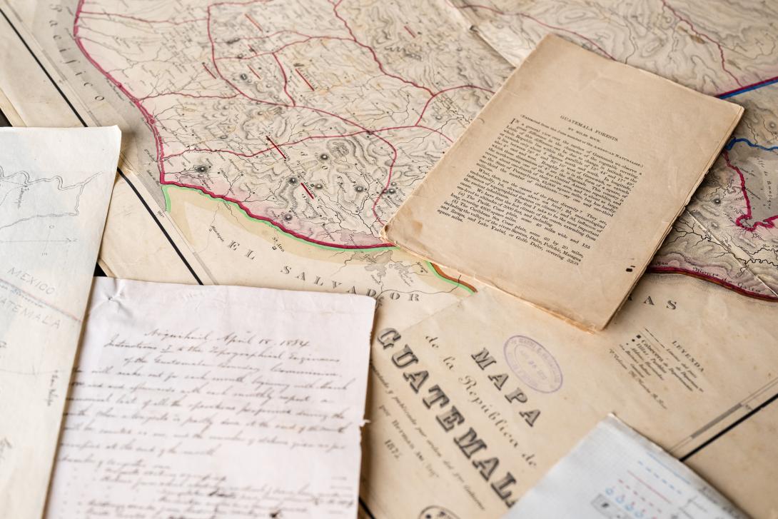 An old map of Guatemala lies on a table